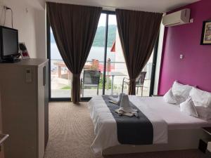a hotel room with a bed with a towel on it at Casa Doma Orsova in Orşova