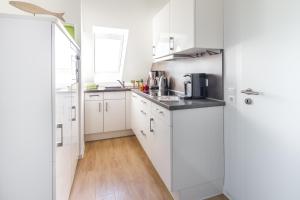 Kuchyň nebo kuchyňský kout v ubytování Haus an den Dünen