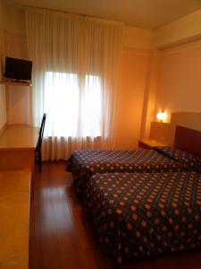 Postel nebo postele na pokoji v ubytování Hotel Palladio