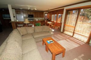 a living room with a couch and a table at Mountainback 60 Corner Unit in Mammoth Lakes