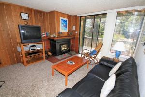 a living room with a couch and a television at Crestview #17 in Mammoth Lakes
