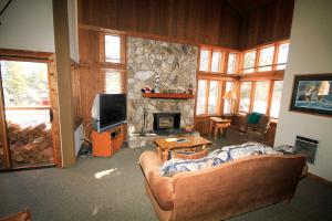 a living room with a couch and a fireplace at Mountainback #63, Loft, Den in Mammoth Lakes +5 photos