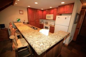 a kitchen with a counter top and a refrigerator at Mountainback #63, Loft, Den in Mammoth Lakes