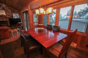a dining room with a wooden table and chairs at Mountainback #52, Loft, Corner in Mammoth Lakes