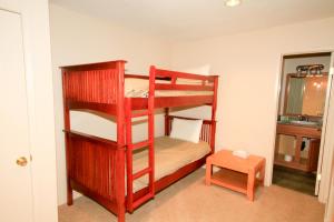 a room with two bunk beds and a table at Crestview #63 in Mammoth Lakes
