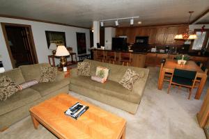 a living room with a couch and a table at Mountainback 72 Corner Unit in Mammoth Lakes