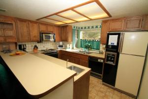 a kitchen with a refrigerator and a sink at Forest Creek #3, Pet accepted in Mammoth Lakes