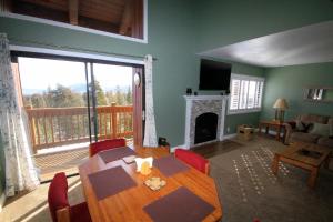 a dining room with a table and a fireplace at Mammoth Ski & Racquet Club #66 in Mammoth Lakes