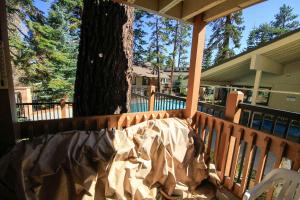 a porch with a tree with a blanket on it at Discovery 4 #137 in Mammoth Lakes