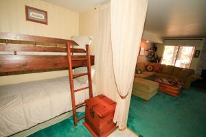 a bedroom with a bunk bed and a living room at Discovery 4 #137 in Mammoth Lakes