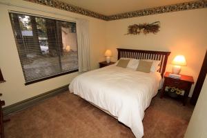 a bedroom with a bed and a large window at Discovery 4 #153 in Mammoth Lakes