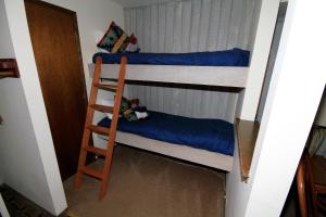 two bunk beds in a room with a ladder at Discovery 4 #135 in Mammoth Lakes