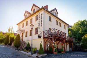 a large white building on the side of a street at Pensjonat Miejski in Zgorzelec