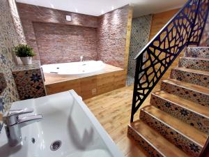 a bathroom with a bath tub and a staircase at Canti apartments in Novi Sad