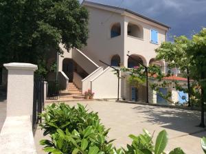 a white house with stairs and a fence at Apartment Pin in Pinezici