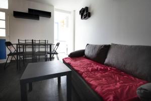 ein Wohnzimmer mit einem Sofa und einem Tisch in der Unterkunft Appartement 2 pièces de 48 M2 in Aix-les-Bains