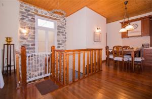 a dining room and living room with a stone wall at "En Hatipi" in Sparti
