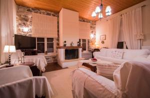 a living room with white furniture and a fireplace at "En Hatipi" in Sparti