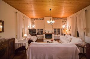 a living room with white furniture and a fireplace at "En Hatipi" in Sparti