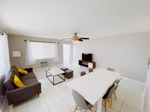 a living room with a couch and a table at The Jasmine Apartments in Fort Lauderdale