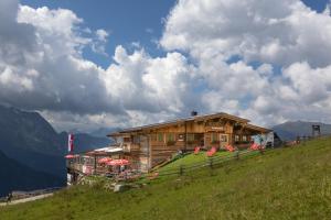 a wooden house on top of a hill at Ahornlodge in Mayrhofen
