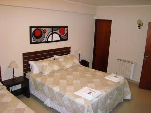 a bedroom with a bed and a stained glass window at Hotel Punta Lavalle in San Luis