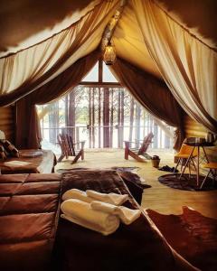 a bedroom with two beds and a large window at Tedesco Eco Park in São Francisco de Paula
