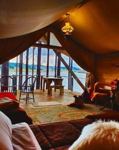 a living room with a tent with a view of the water at Tedesco Eco Park in São Francisco de Paula