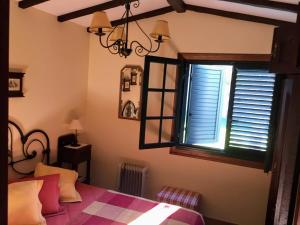sypialnia z łóżkiem i oknem z okiennicami w obiekcie Un Paraiso Junto al Mar w mieście Bueu
