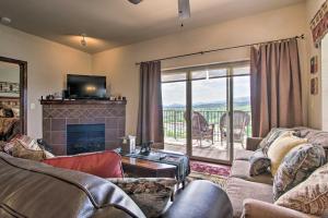 a living room with couches and a fireplace at 2 Mi to Attractions Pigeon Forge Condo in Pigeon Forge