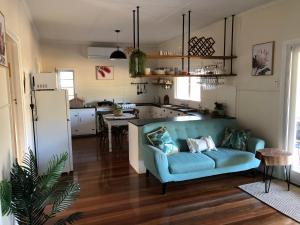 a living room with a blue couch in a kitchen at Moongalba Cottage in Kerry