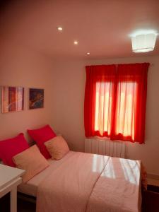 a bedroom with a bed with a red window at Rive gauche in Cuffies