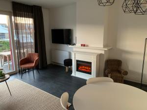 a living room with a fireplace and a table at Water Villa Workum in Workum