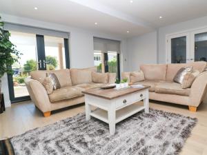 
a living room filled with furniture and a couch at Driftwood Haven in St Ives

