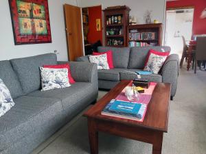a living room with two couches and a coffee table at Rotorua City Homestay in Rotorua