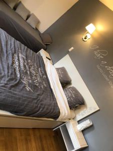 a room with a bed on a display with a book at Chez Celine et Philippe chambre Marie dans propriété de charme avec piscine in Le Fossat