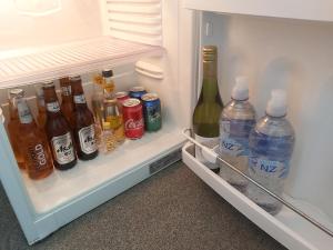 an open refrigerator filled with lots of bottles of alcohol at Rotorua City Homestay in Rotorua