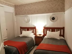 Ένα ή περισσότερα κρεβάτια σε δωμάτιο στο Hostal Mackay Temuco