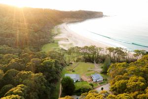 an aerial view of a house next to a beach at Pebbly Beach Escape in East Lynne