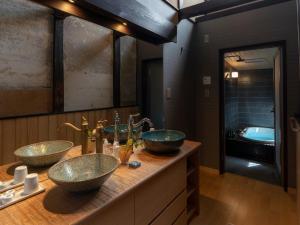 a bathroom with two sinks on a counter at Gion Shirakawa Kouki Machiya House in Kyoto +32 photos