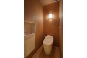 a small bathroom with a toilet and a window at Masarigusa Machiya House in Kyoto +26 photos