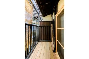 an empty hallway of a building with a balcony at Nadeshiko Shirakawa Machiya House in Kyoto