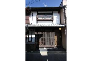 a building with a gate in front of it at Azuki an Machiya House in Kyoto