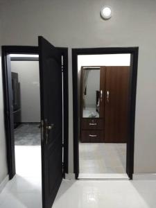 a room with two doors and a mirror at The Winford Boutique Hotel Achimota in Accra