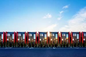 a facade of a building with red and blue barriers at HOTEL R9 The Yard Oyama Kizawa in Oyama