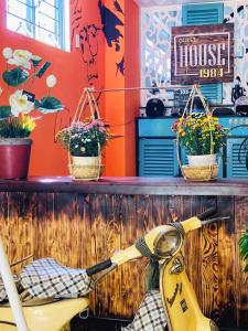 a yellow scooter parked in a room with plants at 1984House in Quy Nhon