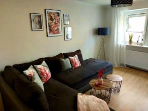 a living room with a couch and a table at Apartment Schweich-Issel Familie Lentes NEU RENOVIERT in Schweich