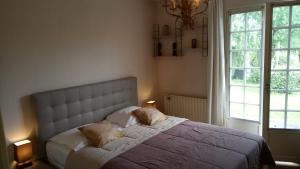 a bedroom with a bed with two pillows on it at Les Gites Lussacois in Lussac-les-Châteaux