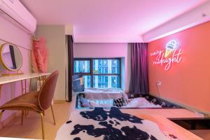 a childs bedroom with pink walls and a bed in it at loft Apartment with slide hammock with movie viewing in Hangzhou