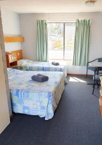 a room with two beds and a window at Lacepede Bay Motel in Kingston South East